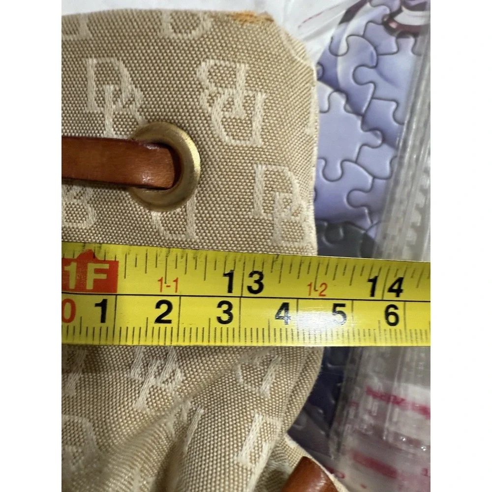 Dooney and Bourke Beige Canvas and Leather Signature Tassel Tote Handbag‎